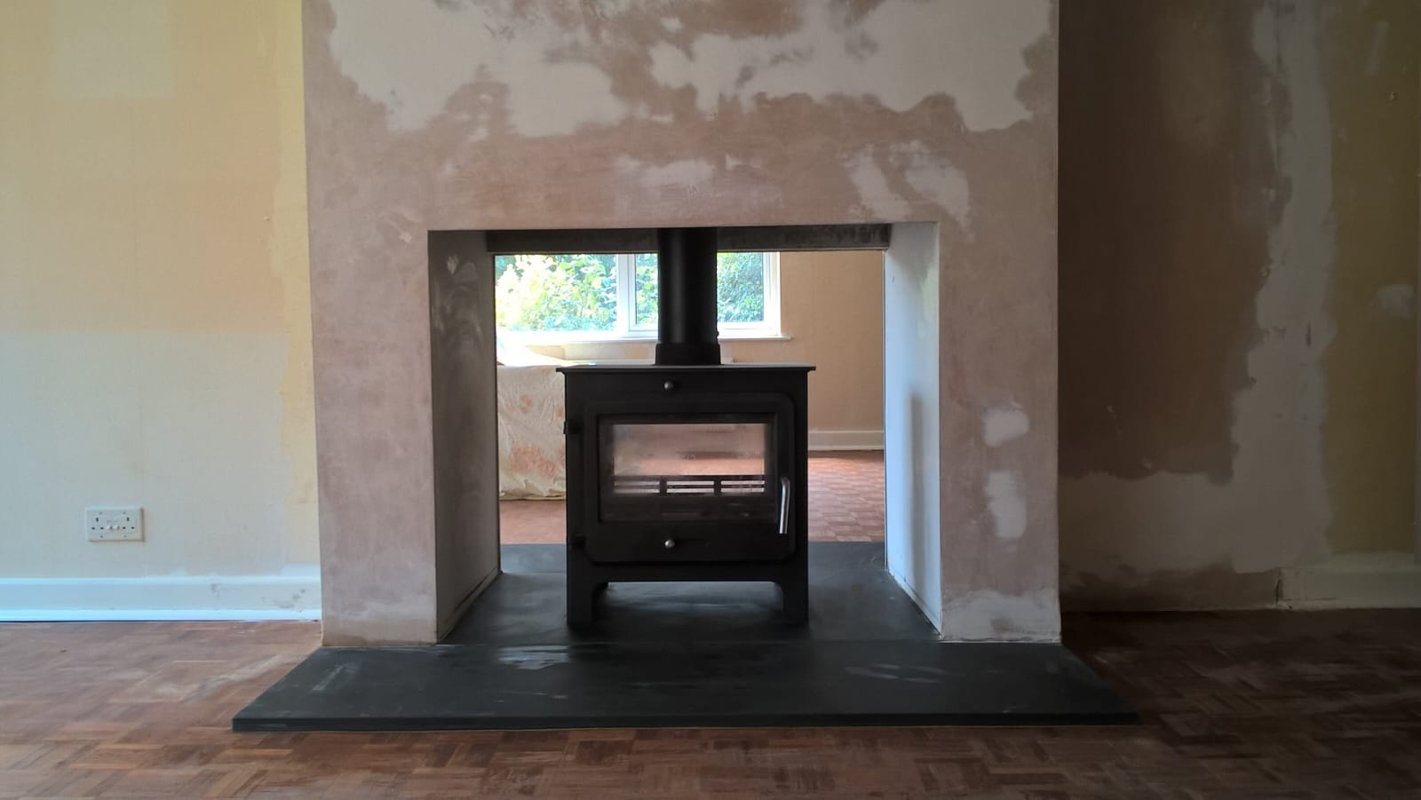 Bespoke chimney breast reconfiguration finished around a new stove