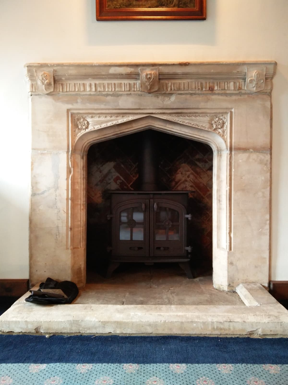 Restored Tudor-arch stone fireplace in a listed Berkshire property