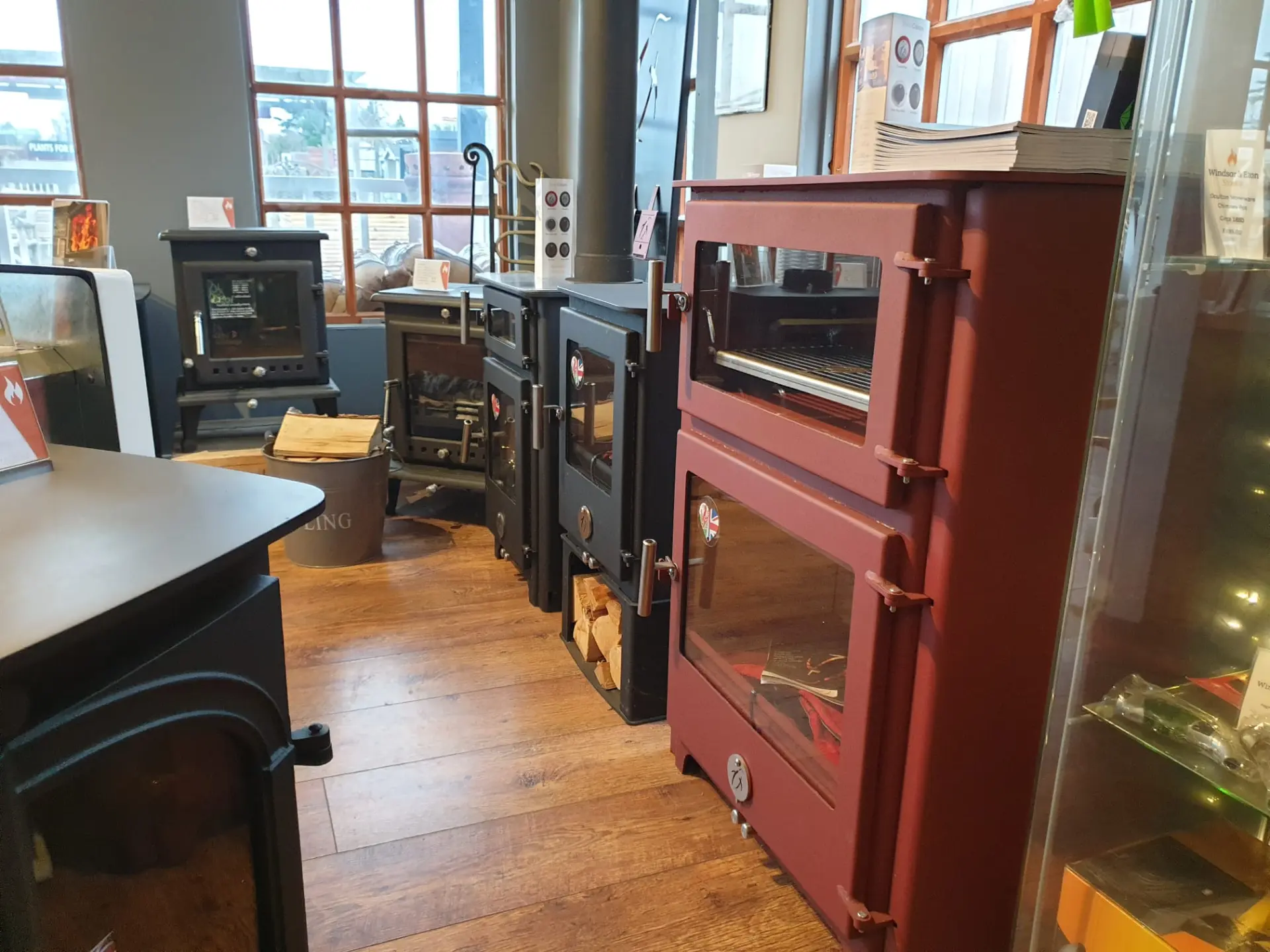 Range cooker and traditional multi-fuel stoves lined up in the showroom