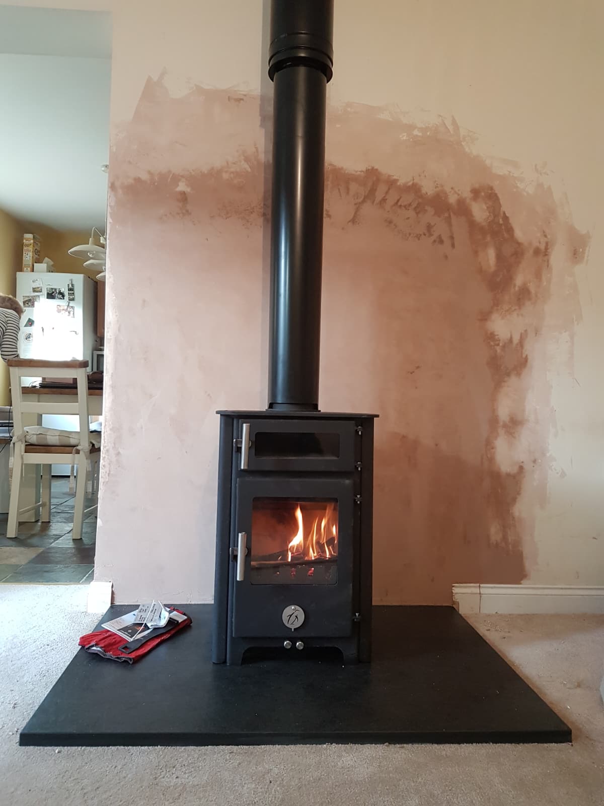 Multi-fuel stove installation against a freshly plastered chimney breast in Windsor