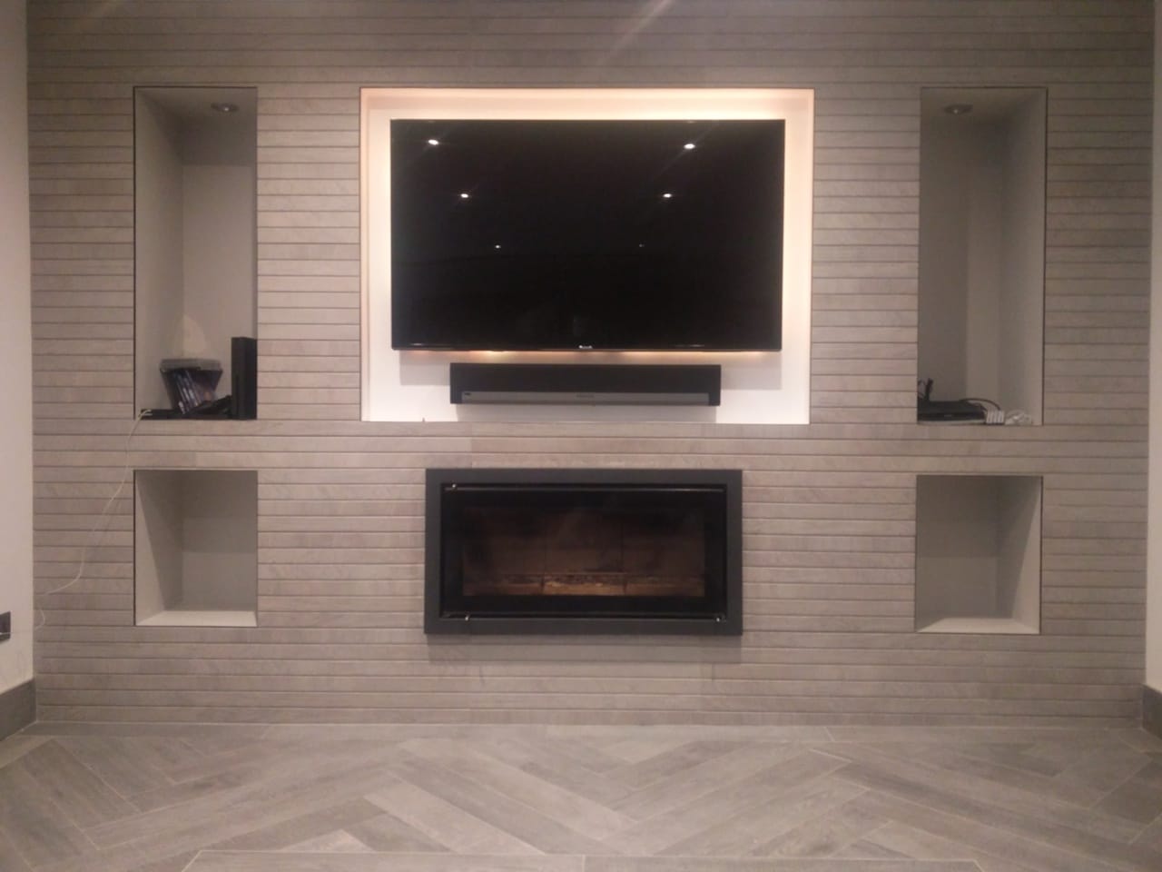 Bespoke media wall with inset TV, gas fire and symmetric alcove shelving